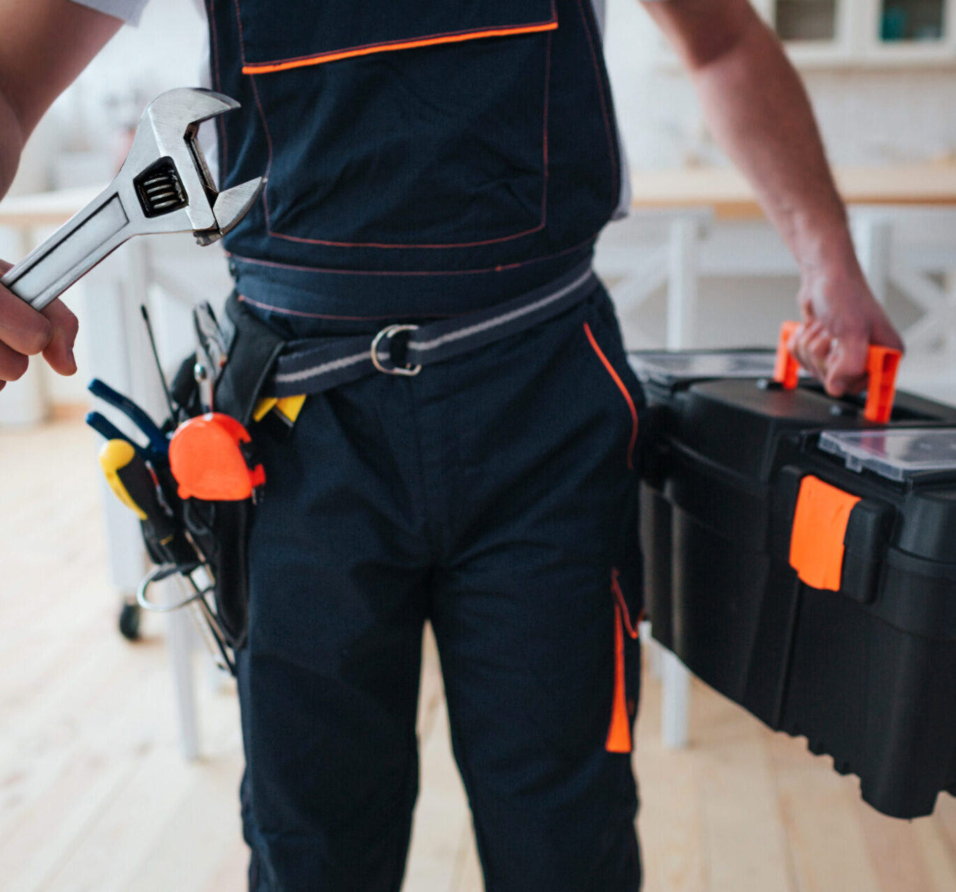 handyman holding toolbox wrench hands scaled